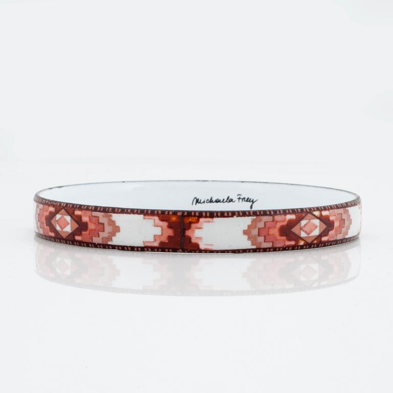 A bangle by Michaela Frey with multi-coloured enamel decoration.