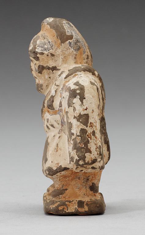A small potted figure of a man, Han dynasty (206 BC - 220 AD).