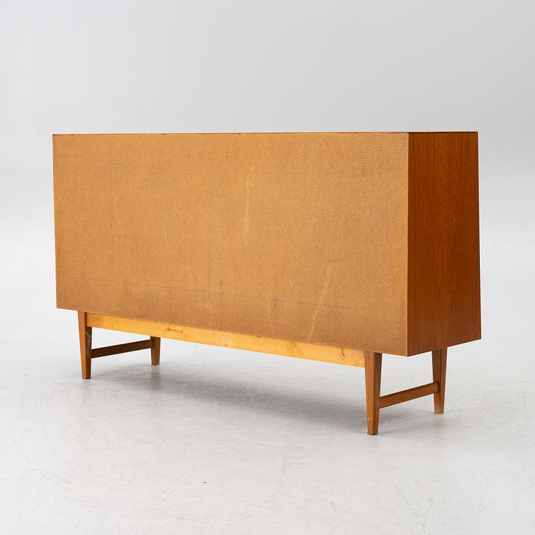 A mid20th century teak-veneered sideboard.