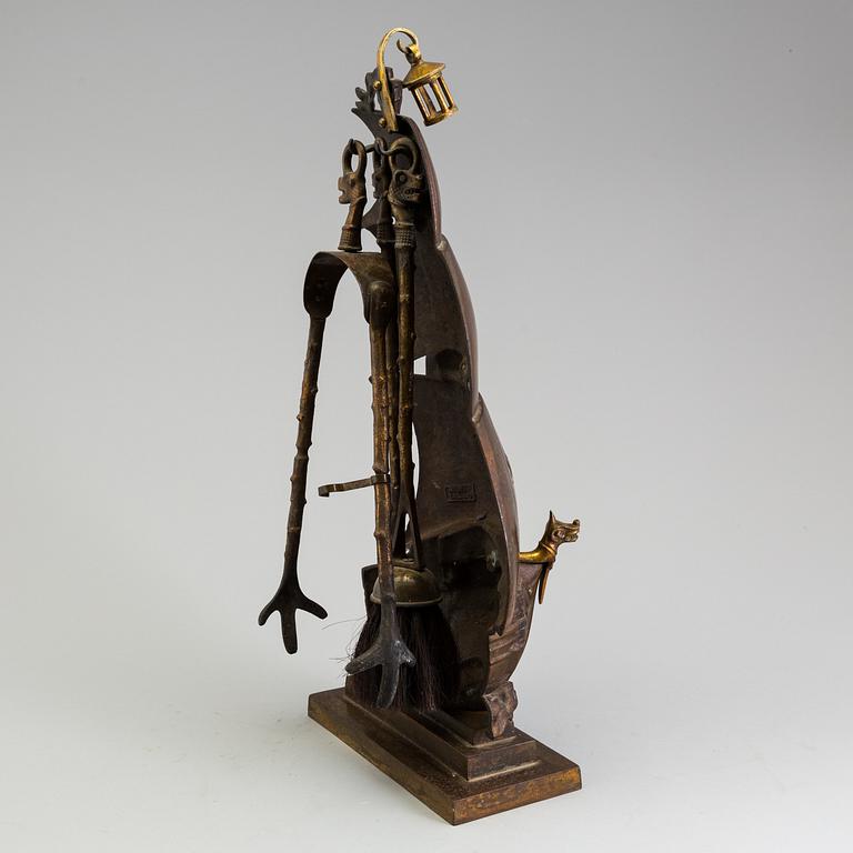 A set of three, early 20th century, bronze fire irons together with a stand, Nestor, England.