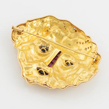 Brosch 18K guld med runda briljantslipade diamanter samt färgstenar.