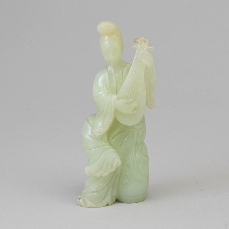 An early 20th century Chinese serpentine stone figure of an elegant lady.