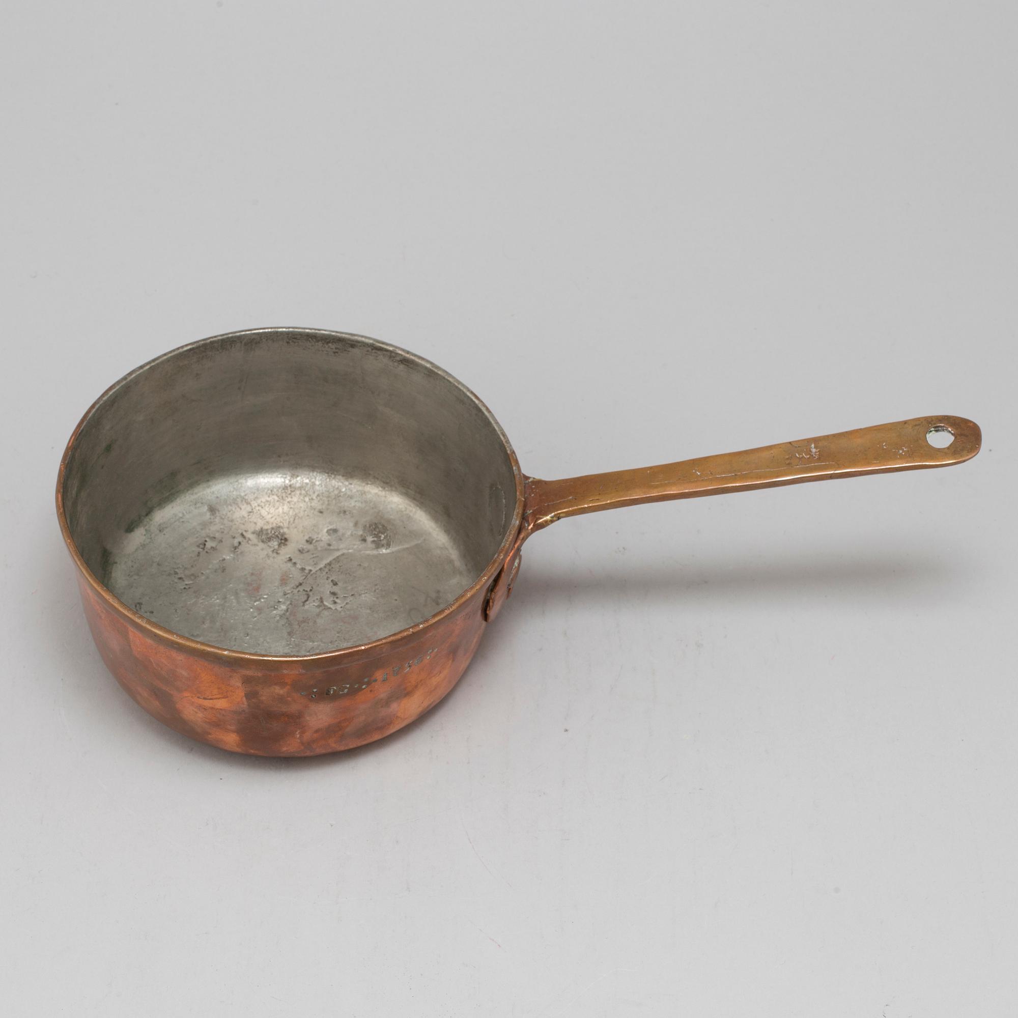 A copper saucepan marked FG 1756.
