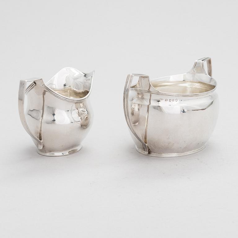 An early 19th-century, sterling silver sugar bowl, mark of Elizabeth Morley, and a cream jug, marked A.B, London 1808.