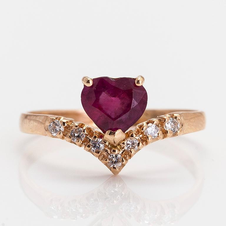 A 14K gold ring, with a heart-shaped ruby and diamonds.
