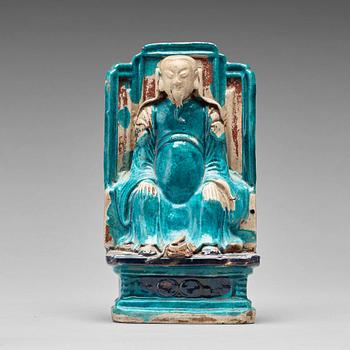 A turquoise and purple glazed figure of a dignitary, Qing dynasty, Kangxi (1662-1722).