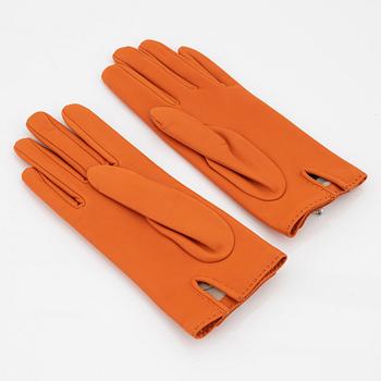 Hermès, a pair of orange kidskin and lambskin gloves, french size 8.