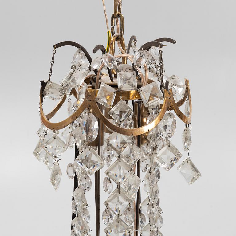 A Louis XVI gilt-brass and cut glass nine-light chandelier, circa 1800.