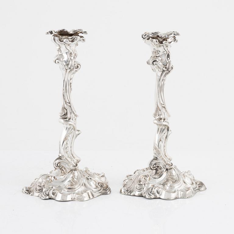 A pair of rococo style silver candle sticks by Pehr Fredrik Palmgren, Stockhom 1851.