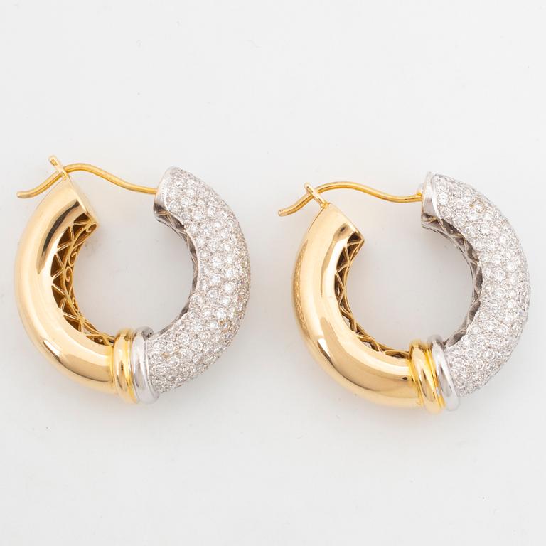 Gold and brilliant-cut diamond hoop earrings.