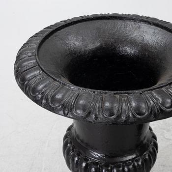 A pair of cast iron garden urns, 20th century.