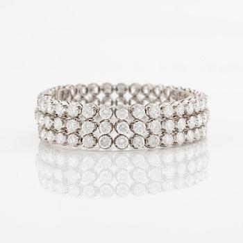 A platinum bracelet set with round brilliant-cut diamonds.