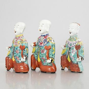 A group of three Chinese porcelain 'Laughing boys' figures, Qing dynasty and later.