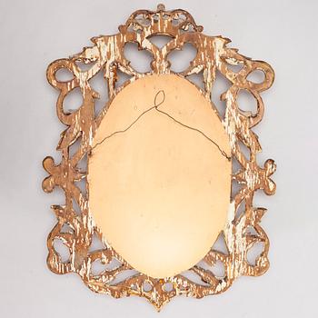 A gilded and bronzed woodcut leaf decorated mirror, second half of the 19th century.