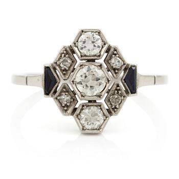 580. A platinum ring set with round brilliant-cut diamonds and sapphires, Art Déco.