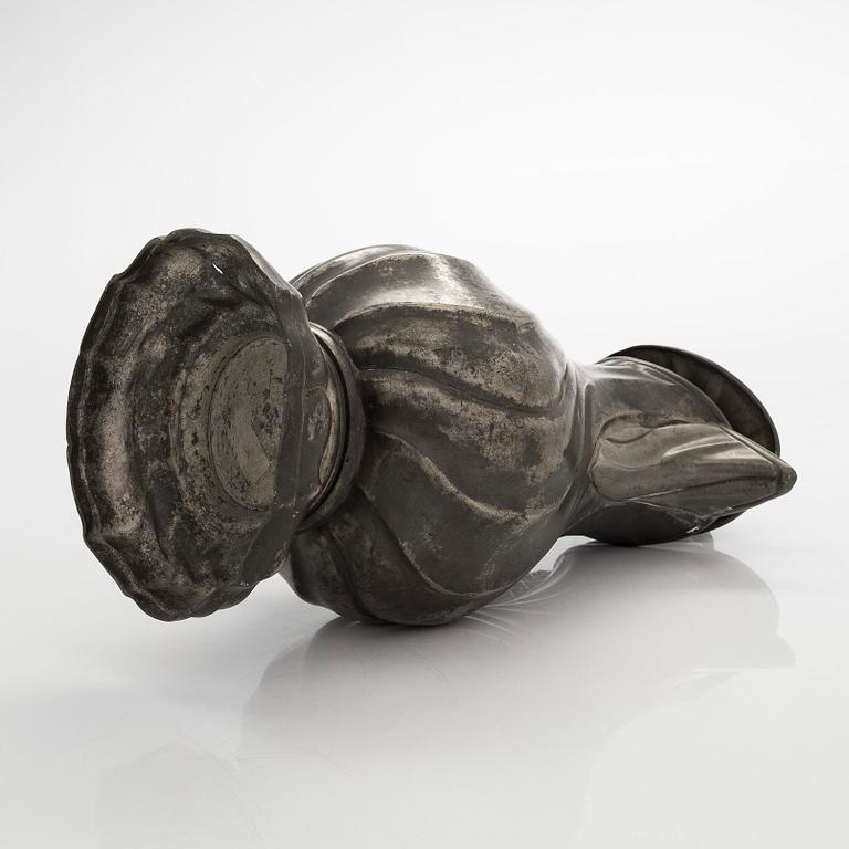 A mid 18th century rococo pewter jug.