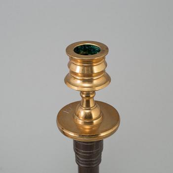 A pair of early 20th century brass and wood candlesticks, no 87, Gusums Bruk, Sweden.