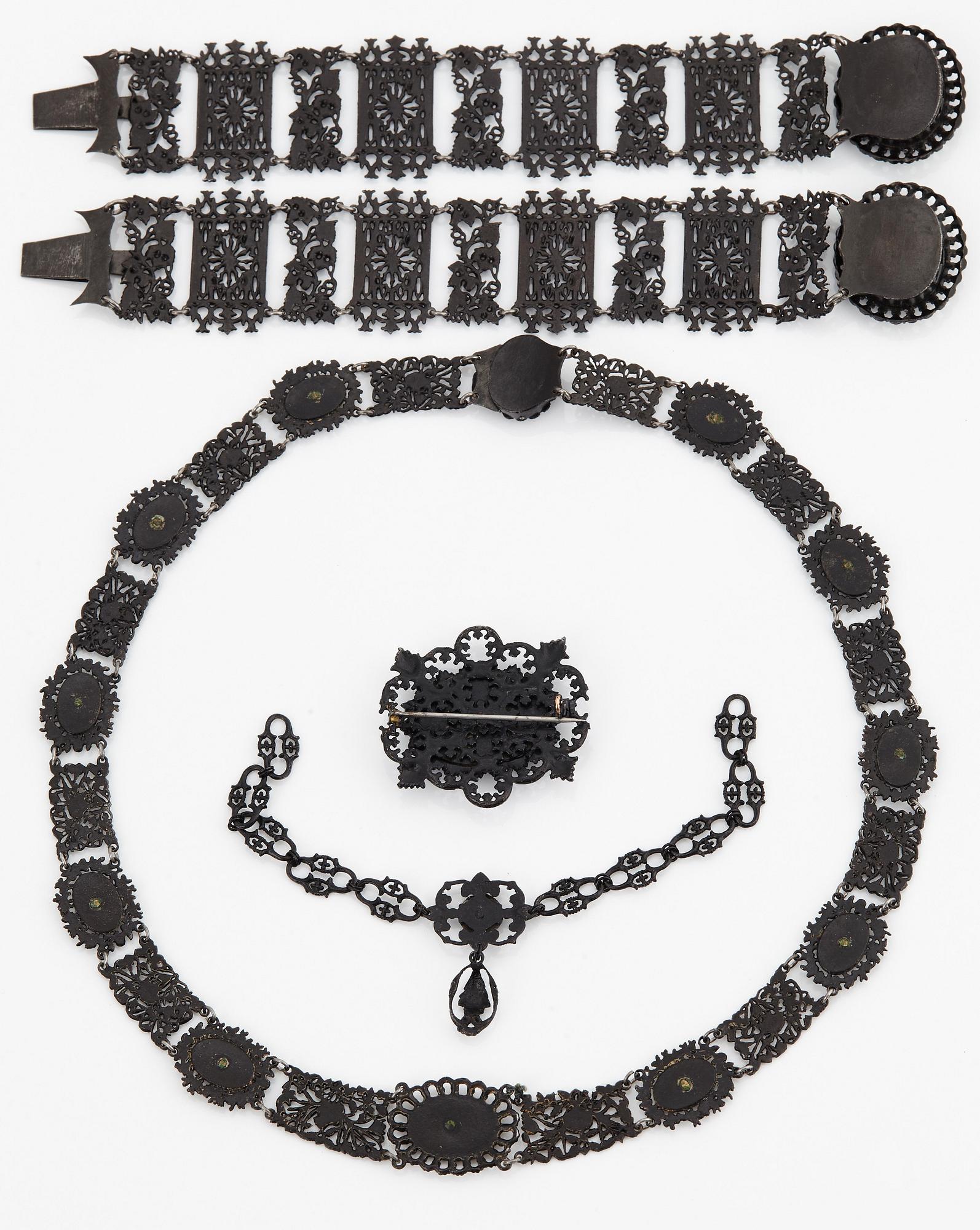 A Berlin steel and iron parure comprising a necklace, two bracelets and a brooch.