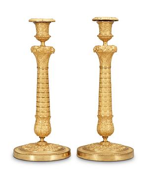 524. A pair of French Empire early 19th Century candlesticks.