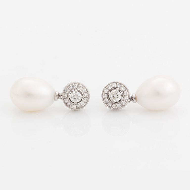 A pair of 18K white gold and cultured pearls earrings set with round brilliant-cut diamonds.