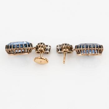 A pair of 14K gold earrings with faceted sapphires and old-cut diamonds.