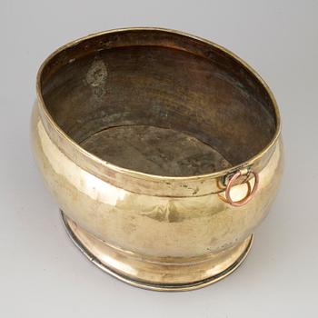 A 18th century brass champagne cooler.