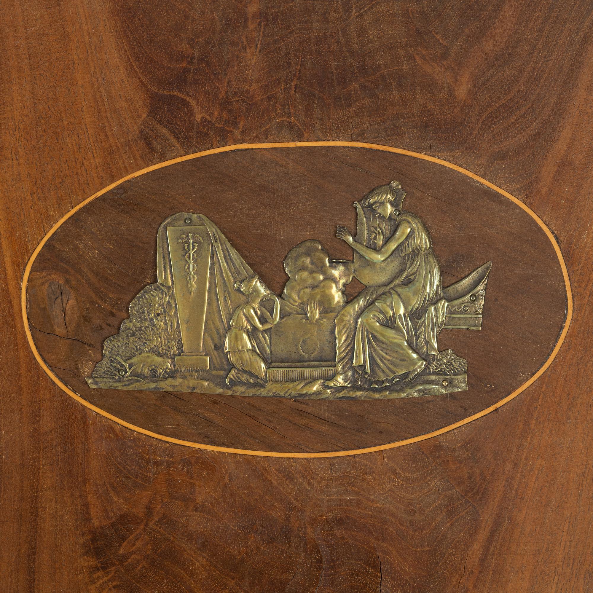 A mahogany veneered Empire mirror, first half of the 19th Century.