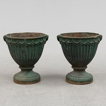 A pair of early 20th century iron garden urns.