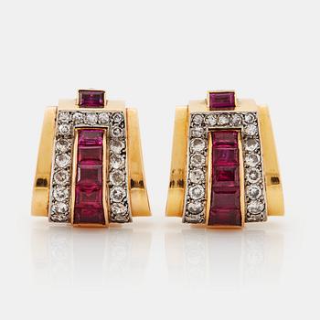 928. A pair of Boucheron earrings in 18K gold and platinum set with rubies and round brilliant-cut diamonds.