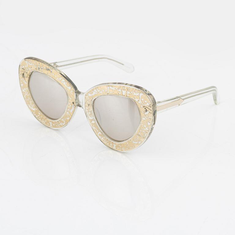 Karen Walker, a pair of "Intergalactic" sunglasses.