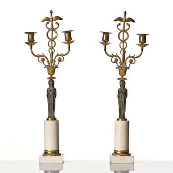 A pair of late Gustavian white marble and bronze candelabra.