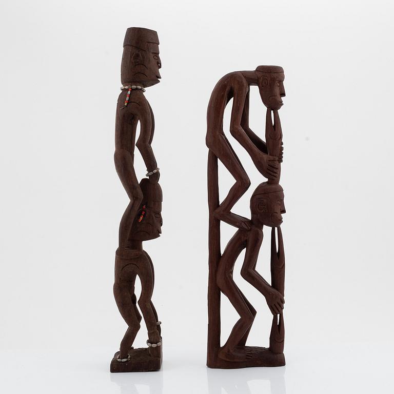 A group of three wooden Asmat sculptures, 20th Century.