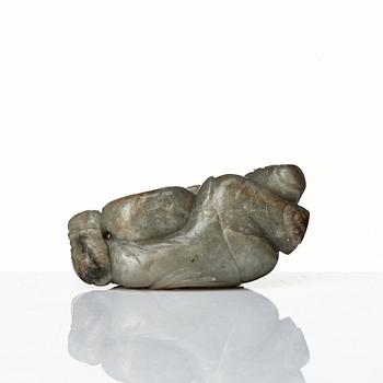 A neprite sculpture of a reclining boy with a duck, late Qing dynasty.