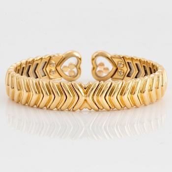 A Chopard "Happy Diamond" bangle in 18K gold.
