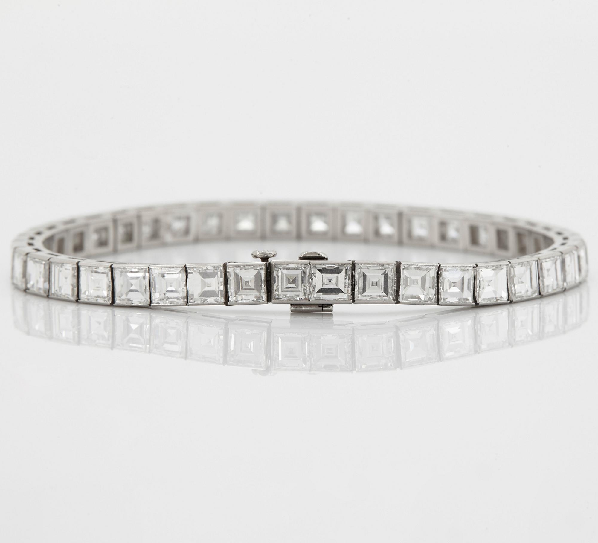 A platinum bracelet set with carré cut diamonds.