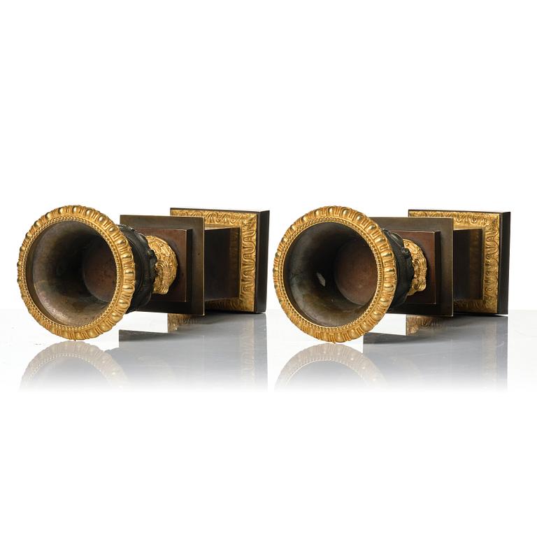 A pair of French Louis Philippe gilt and patinated bronze urns, first part 19th century.