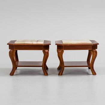 a pair of mahogany and marble tables from the late 20th century.