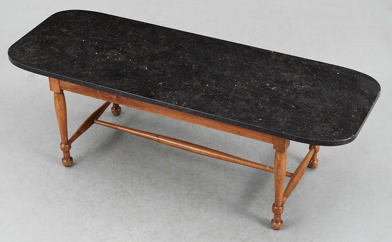 A Josef Frank black stone top sofa table by Svenskt Tenn.