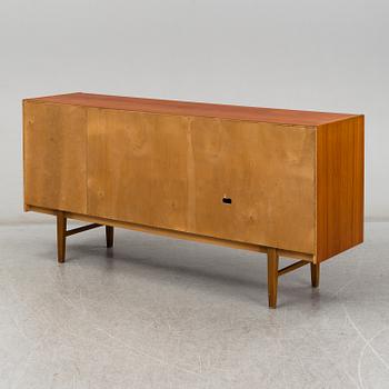 A 1960's teak vaneered sideboard.