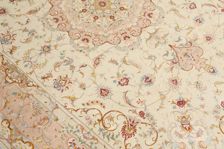 A Tabriz part silk carpet, signed, 305 x 203 cm.