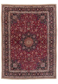 428. A semi-antique Mashad carpet, signed Saber, c. 401 x 300 cm.