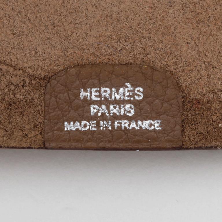 HERMÈS, a grey wallet and notebook cover, "Dogon" and "Ulysse".