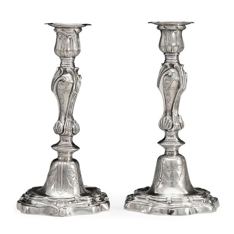 A pair of Rococo 18th century argent haché candlesticks.
