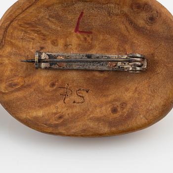 A brooch attributed to Per Sunna and a pendant, both in birch and engraved reindeer horn,
