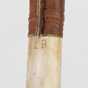 A reindeer horn knife signed LB.