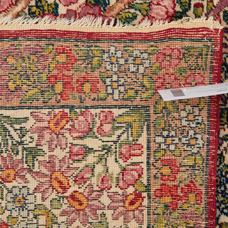 A RUG, a semi-antique Kerman "mille-fleur", ca 198,5 x 136,5 cm.