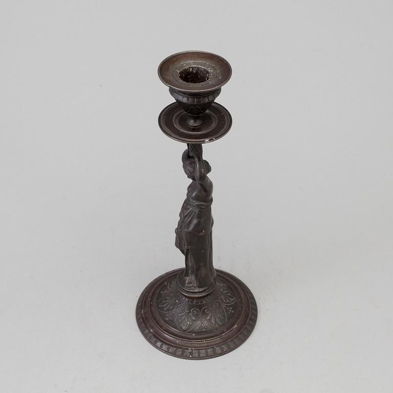 A 19th century iron candlestick marked F.L Vombach Offenbach A/M.