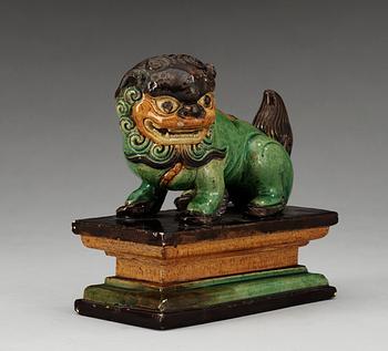 A green, yellow and aubergine glazed figure of a dog, Qing dynasty, 19th Century.