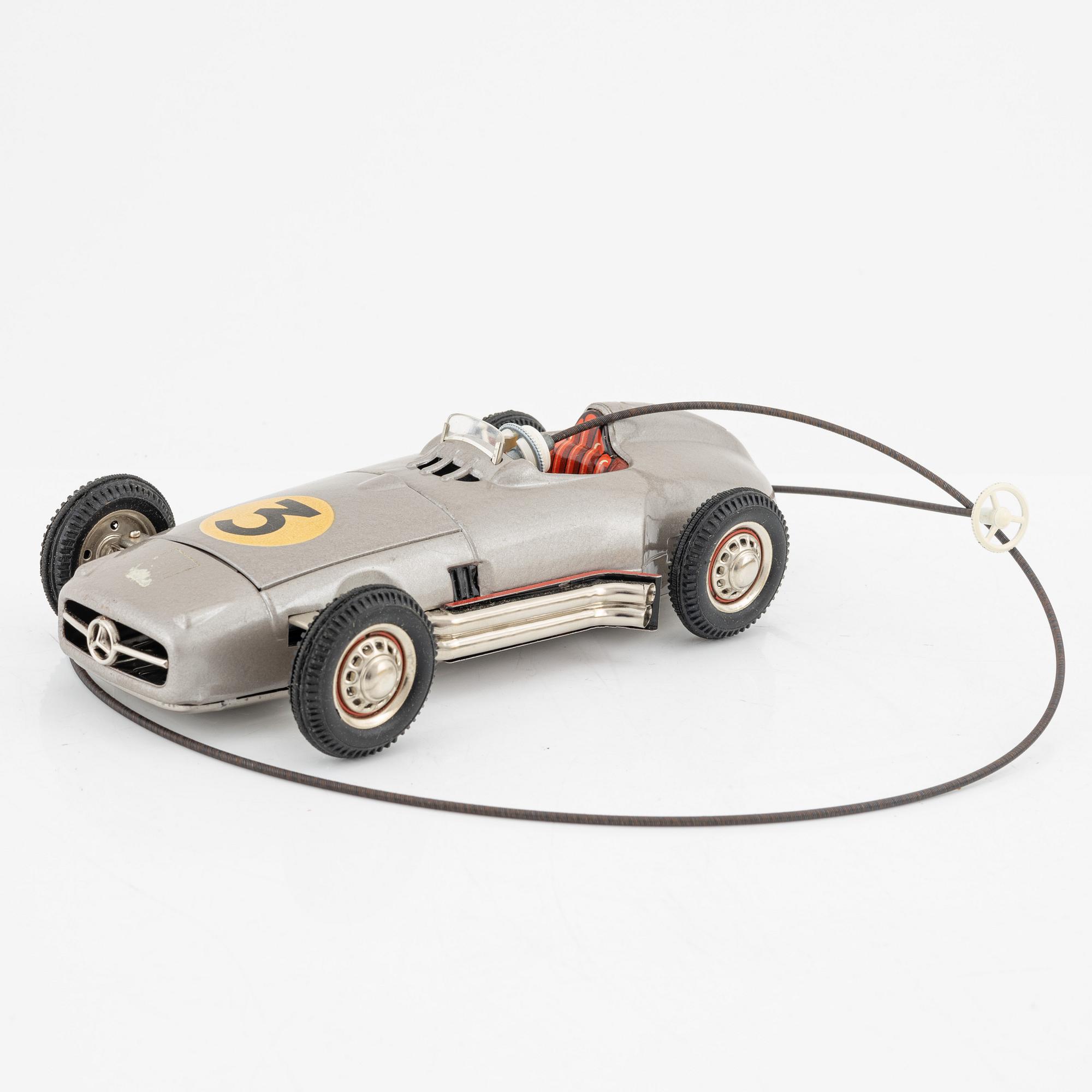 Five tin toys, including Arnold and Gama, 20th Century.