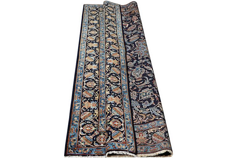 A Kashmar rug, part silk, c. 234 x 142 cm.